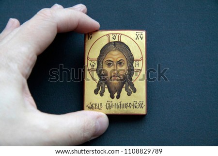Orthodox icon "image of our Lord Jesus Christ" in hand on an isolated black background