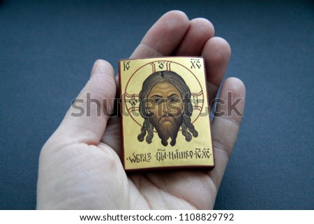 Orthodox icon "image of our Lord Jesus Christ" in hand on an isolated black background