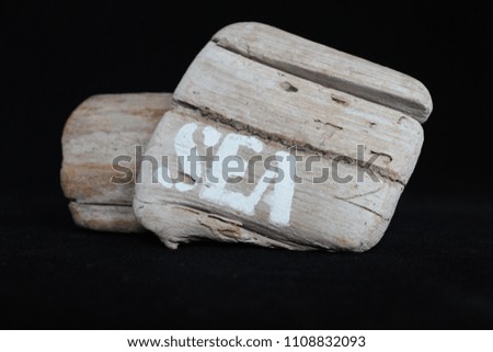 driftwood with the words sea