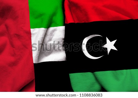 United Arab Emirates and Libya flag on cloth texture