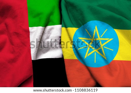 United Arab Emirates and Ethiopia flag on cloth texture
