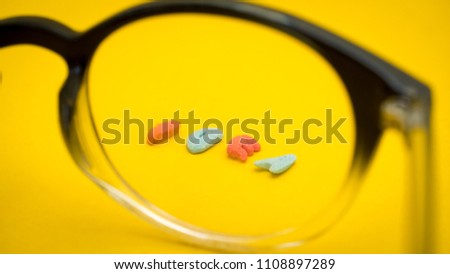 Glasses with idea letters made of sugar on yellow background