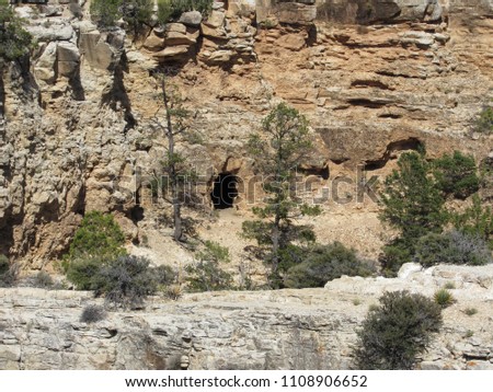 A cave opening in the cliffs of the Grand Canyon seen from the South Rim 