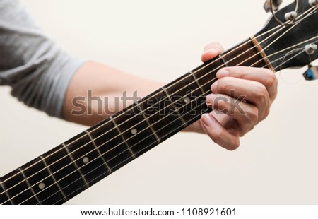 The musicians are catching the guitar chords is A chord on white background,Guitar chords,Selective focus
