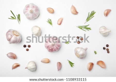 Flat lay composition with garlic on light background Royalty-Free Stock Photo #1108933115