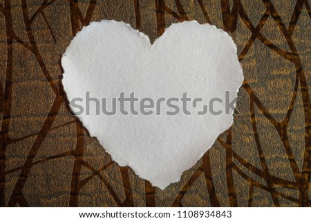 Heart shaped white sheet of paper on a textured background for love notes