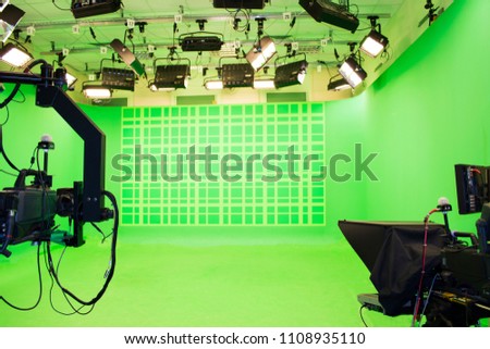 Modern empty green photo studio with modern style movie camera