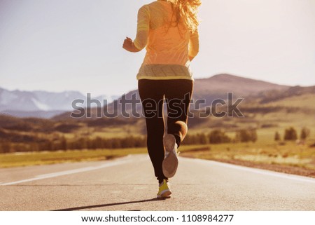 Closeup photo of running woman at straight road. Run concept