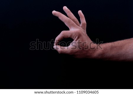 
hand on black background, holding hand