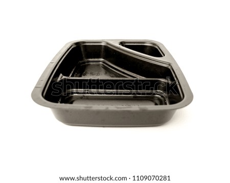 A black disposable plastic food tray on the white background. 