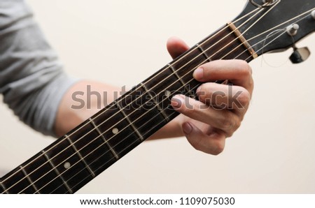 Selective focus,Guitarist,The musicians are catching the guitar chords is D chord on white background