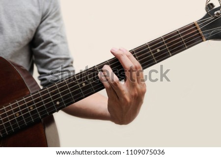 The musicians are catching the guitar chords is A minor chord full bar on white background,Guitar chords,Selective focus,Guitarist