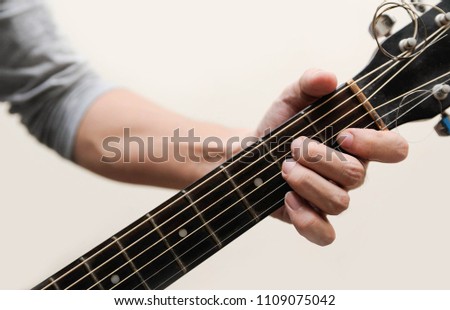 Guitar chords,Selective focus,Guitarist,The musicians are catching the guitar chords is A minor chord on white background
