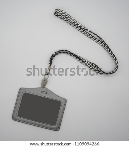 Grey leather card holder with detachable weaving neck strap in different colors isolated on white background.