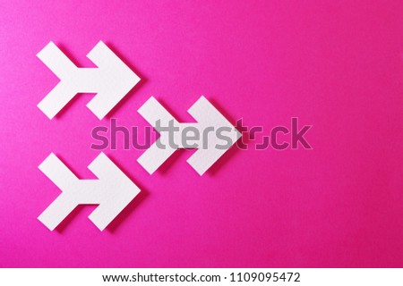 Paper arrow shapes on color background, ideal for your creative projects or direction topics.