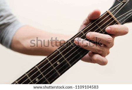 Selective focus,Guitarist,The musician is holding the guitar chords calling C chord on white background