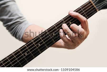 Guitar chords,Selective focus,Guitarist,The musician is holding the guitar chords is B minor chord on white background