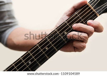Guitar chords,Selective focus,Guitarist,The musician is holding the guitar chords is D minor chord on white background