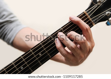 Guitar chords,Selective focus,Guitarist,The musician is holding guitar chord on white background and called,F chord