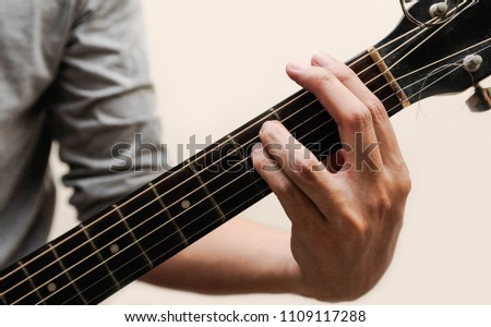Guitar chords,Selective focus,Guitarist,The musician holding guitar chord on white background,F minor chord