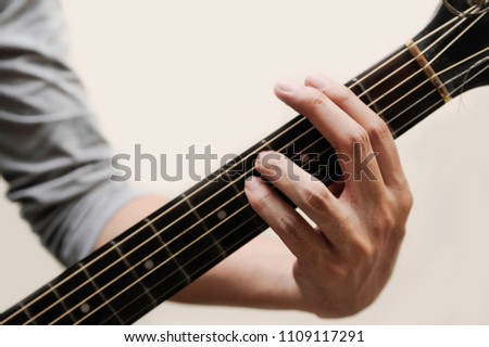 Guitar chords,Selective focus,Guitarist,The musician is holding guitar chord on white background,F sharp minor chord