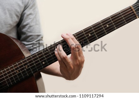 Guitar chords,Selective focus,Guitarist,The musician is holding guitar chord on white background,B minor chord full bar