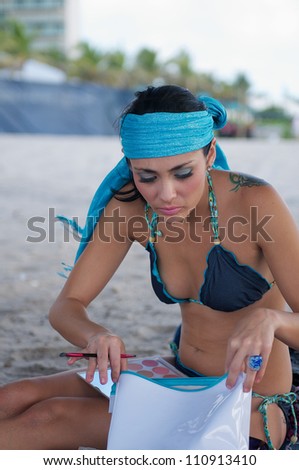 Young woman applying makeup for photos.