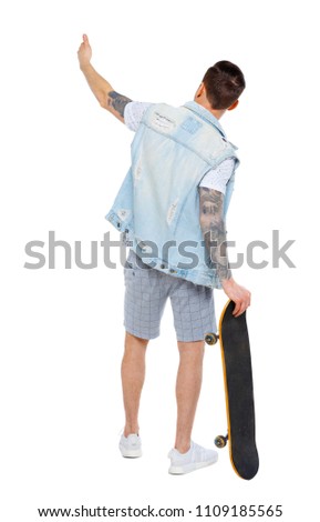 Back view of a pointing man with a skateboard. Rear view people collection.  backside view of person.  Isolated over white background. 