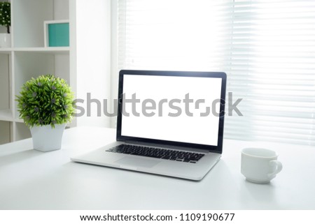 All in one computer, mouse, keyboard, old book, pen, coffee cup and plant vase on wooden table Royalty-Free Stock Photo #1109190677