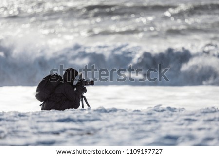 photographer on the coast in winter