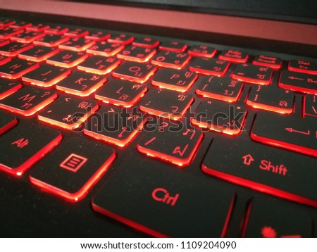 Red keyboard on notebook pad