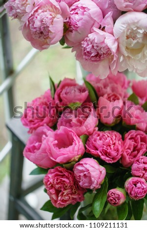 Lovely flowers in glass vase. Beautiful bouquet of pink peonies . Floral composition, scene, daylight. Wallpaper