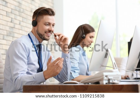 Technical support operators with headsets at workplace Royalty-Free Stock Photo #1109215838