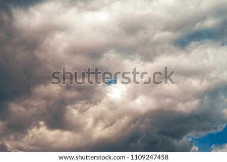 Summer white clouds fly across a bright blue sky