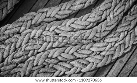 Black and white close up picture of old frayed boat ropes.