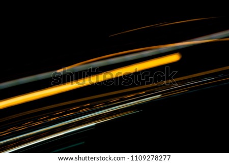 Orange and bluel backdrop from fast moving glow particles.stripes and Lights   moving fast over dark background.