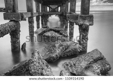 Under The ruins of Jetty, Photo long exposure, Seascape of thailand.Black and white photo
