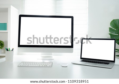 All in one computer, mouse, keyboard, old book, pen, coffee cup and plant vase on wooden table Royalty-Free Stock Photo #1109318951
