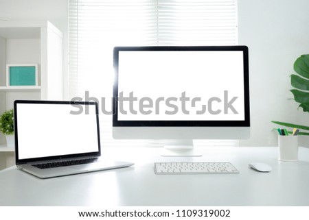 All in one computer, mouse, keyboard, old book, pen, coffee cup and plant vase on wooden table Royalty-Free Stock Photo #1109319002