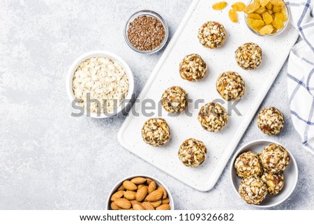 Raw vegan healthy dessert, date and nuts bliss balls, ingredients. Top view, space for text. Royalty-Free Stock Photo #1109326682