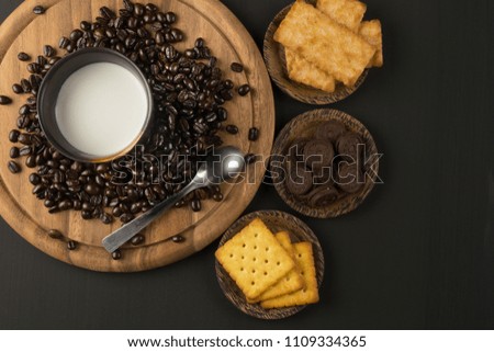 Pictures of coffee beans and snack on wooden backdrop You can decorate it in cafes, equipment, labels, or even for editing purposes.