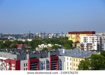 Panorama of the city of Lublin in Poland full of blocks and green trees.
