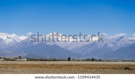 The magic nature, high majestic mountains are covered with white snow under the blue sky