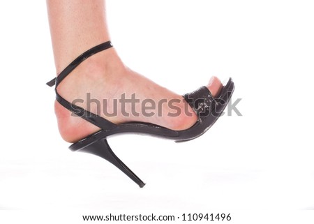 Isolated woman foot in the black shoes with high heel