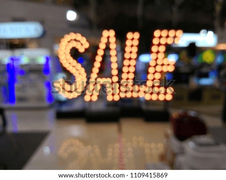 Blur Shopping Mall with sale and discount tag
