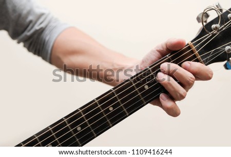 Guitar chords,Selective focus,Guitarist,The musician holding guitar chord on white background,E chord