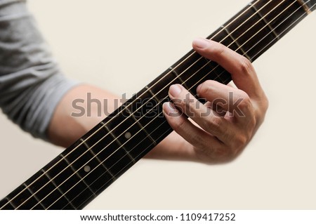 Guitar chords,Selective focus,Guitarist,The musician is holding guitar chord on white background,C minor chord