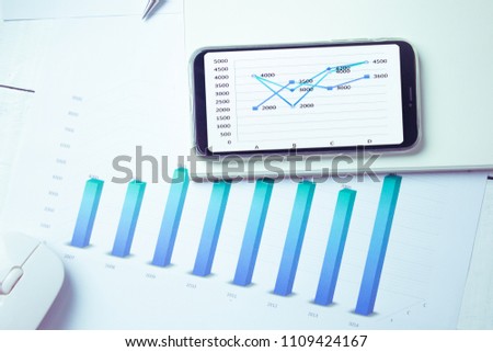 Graphs and charts elements on phone screen  and statistical performance of the company.