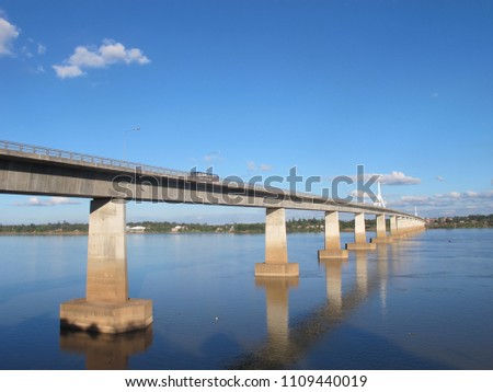 Long bridge over the lake and the blue sky.