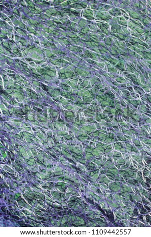 abstract texture woven fiber on a green-purple background